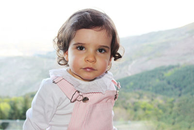 Portrait of cute girl standing outdoors