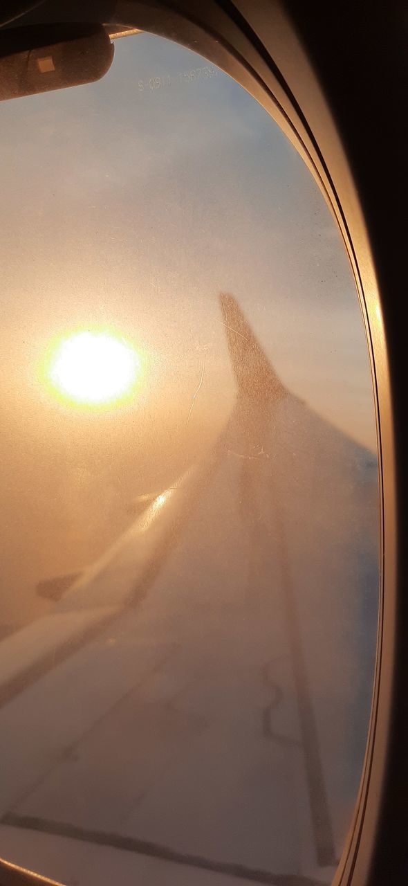 VIEW OF AIRPLANE THROUGH WINDOW