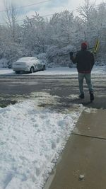 Rear view of man standing in snow