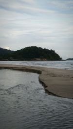 Scenic view of sea against cloudy sky