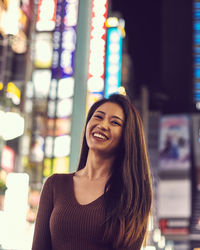 Portrait of a smiling young woman in shinjuku tokyo