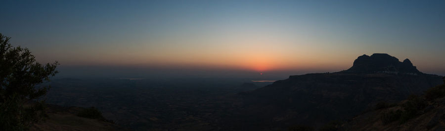 Scenic view of silhouette mountain against sky during sunset