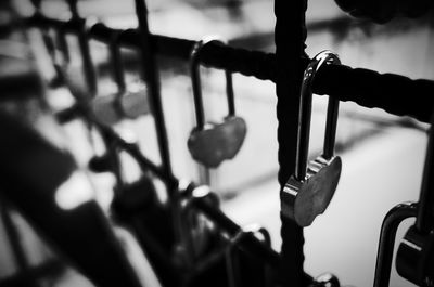 Close-up of padlocks hanging on railing