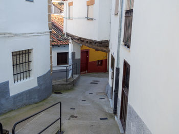 Empty alley amidst buildings in city