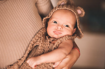 Mother holding newborn baby at home