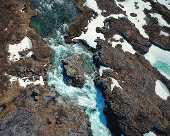 Full frame shot of rocks in sea during winter