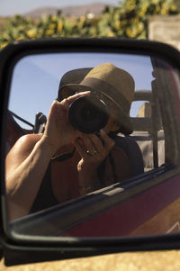 Portrait of man photographing car