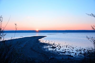 Scenic view of sea against clear sky during sunset