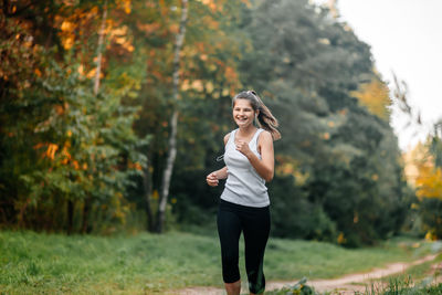 Full length of a smiling young woman on land