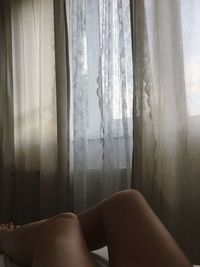 Woman relaxing on window at home