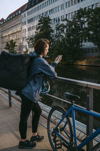 Rear view of man riding bicycle on street