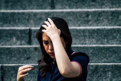 Portrait of woman against wall