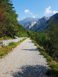 Road amidst plants and mountains against sky