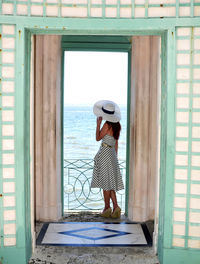 Full length of woman standing by railing