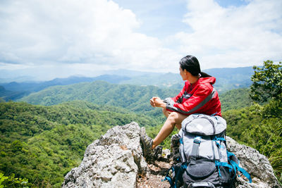 Rear view of woman standing on mountain