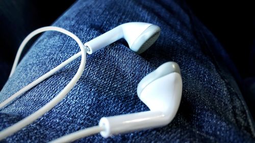 Close-up of headphones on jeans