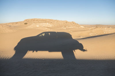 Shadow of off road truck in motion in the desert