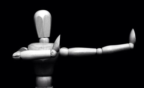 Close-up of hand over black background