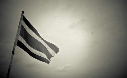 Low angle view of flag against sky