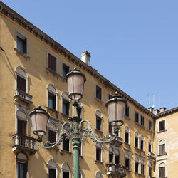 Low angle view of building against clear blue sky