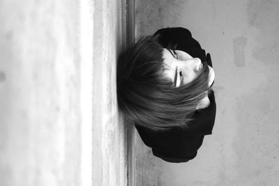 High angle view of woman leaning on wall