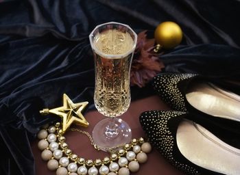 High angle view of alcoholic drink with woman personal accessories on table