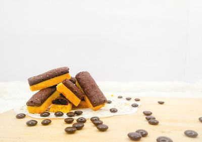 Close-up of chocolate cake on table against white background