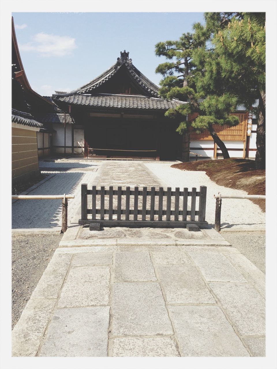 transfer print, tree, built structure, architecture, paving stone, cobblestone, sunlight, steps, footpath, auto post production filter, bench, shadow, tiled floor, building exterior, empty, day, railing, sky, walkway, outdoors