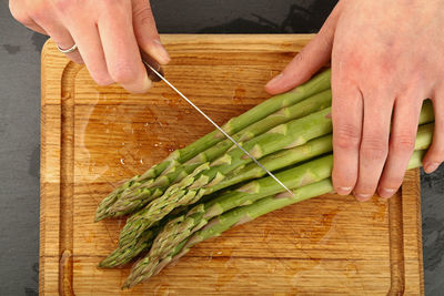 Close-up of hands holding bread on table