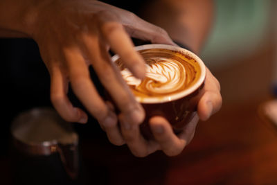 Midsection of woman holding coffee cup