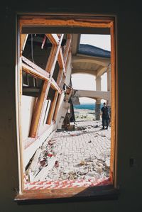 People in sea seen through window