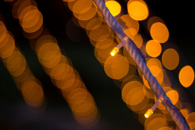 Low angle view of illuminated lights at night