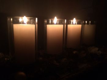 Close-up of illuminated candles in the dark