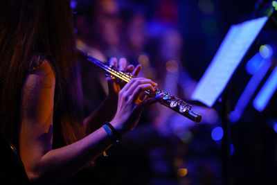 Midsection of woman playing at music concert