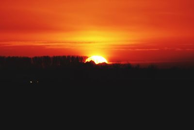 Scenic view of silhouette landscape against romantic sky at sunset