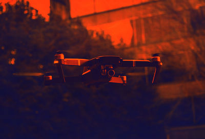 Close-up of drone in city during sunset