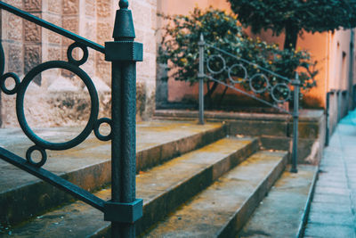 Close-up of metal railing by fence