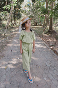 Little girl in dress standing and posing