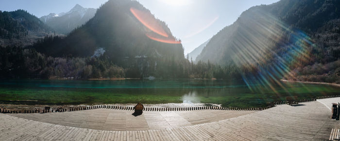 Scenic view of lake by mountains against sky