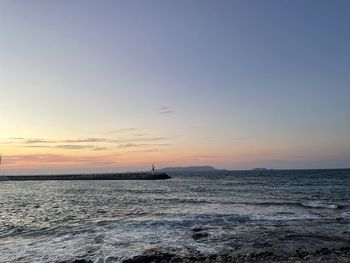 Scenic view of sea against sky at sunset