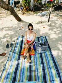 Portrait of young woman sitting on beach