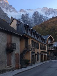 Houses by road against sky during winter