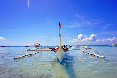 Boats in sea against clear sky