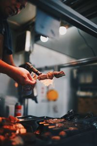 Midsection of person preparing food in kitchen