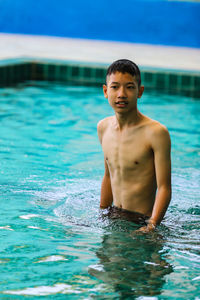 Portrait of shirtless boy in swimming pool