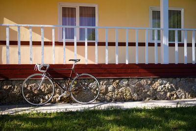 Bicycle parked against building