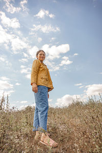 Full length of man standing on field against sky