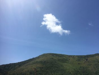 Low angle view of mountain against blue sky
