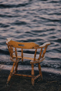 Empty chair on shore at beach