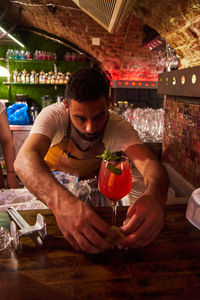 Portrait of young woman preparing food at home